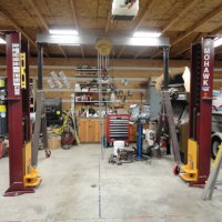 Mohawk two post lift shown installed with low ceiling